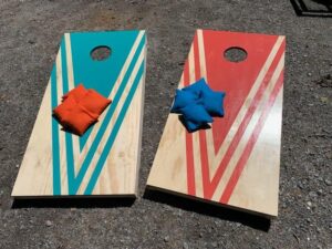 red and blue cornhole boards